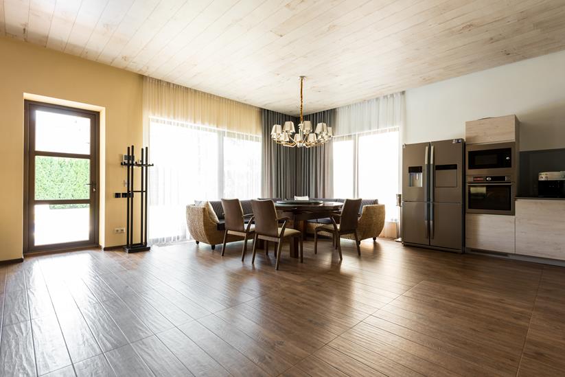 interior view of modern kitchen and dining room with table and chairs